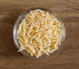 bowl with old Dutch grated cheese on wooden background