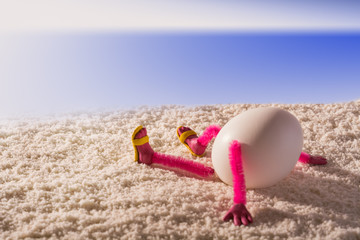 Happy egg lying  on a sandy beach