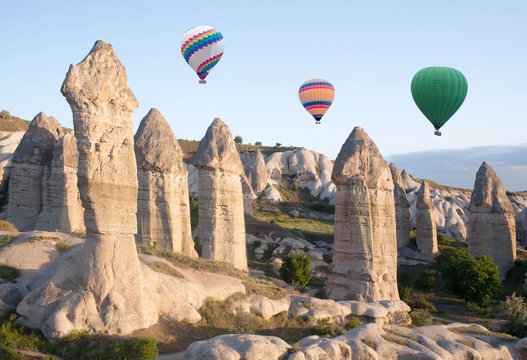 Colorful hot air balloons flying over Gorkundere valley in Cappadocia, Anatolia, Turkey