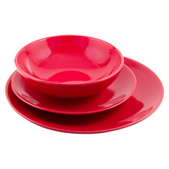 set of red ceramic plates of different shapes, on white background