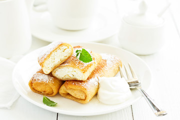 Russian crepes stuffed with curd and cherry.