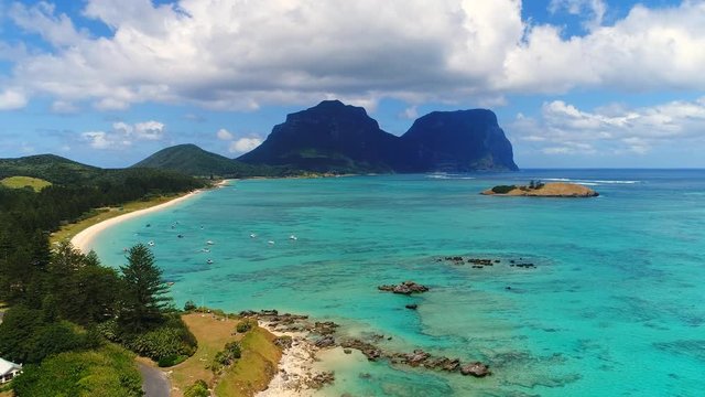 Aerial view of Lord Howe Island (World Heritage-listed paradise), turquoise blue lagoon and Mount Gower on background - New South Wales - Tasman Sea - Australia from above, 4k UHD