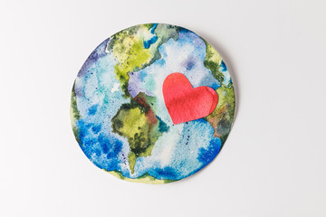 top view of handmade colorful paper globe with red heart isolated on grey, environment protection...