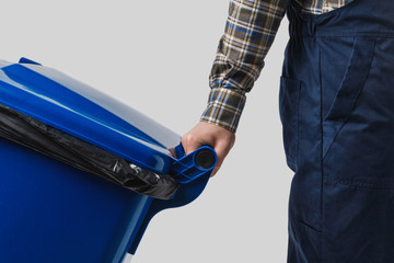partial view of cleaner with trash bin isolated on grey
