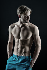 Fototapeta na wymiar Macho show muscular torso in blue shorts