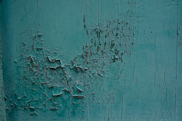 Blue cracked painting on old plaster wall surface