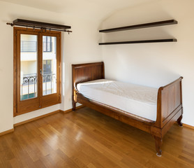 Empty new bedroom, only with wooden bed