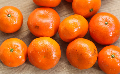 Bunch of fresh Mandarin orange, tangerine citrus fruit on wooden background