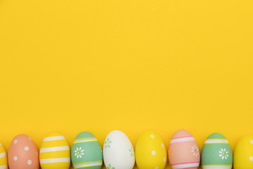 Painted easter eggs on a bright yellow background