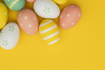 Fototapeta na wymiar Painted easter eggs on a bright yellow background