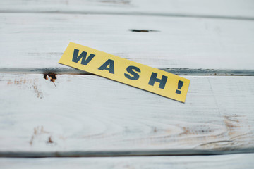 Wash inscription on a white wooden background