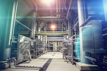 Modern brewery factory interior. Steel tanks or vats for filtration beer, pipe lines and other...