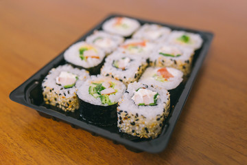 The sushi on the table in the delivery package, ordered in sushi roll