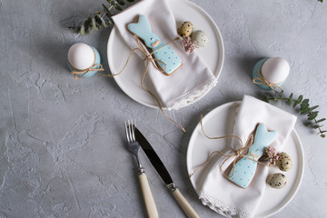 Homemade easter cookies in the shape of  a  funny  rabbit  on white plate. Easter  festive table setting. Holiday decorations.