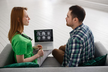 Female doctor and male patient looking at MRI concept healthcare, medical and radiology concept