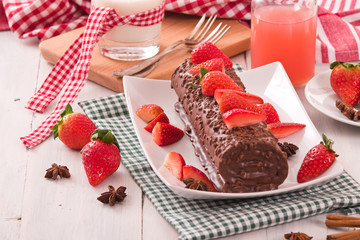 Chocolate roll with strawberries. 