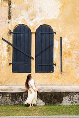Woman near an old house