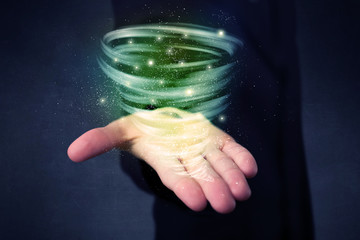 Businessman holding green tornado