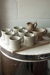 Work in progress standing on the top of the kiln in a ceramic artists home pottery studio