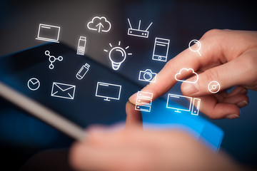 Fingers touching tablet with icons