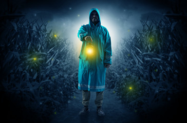 Man coming out from a thicket with lantern