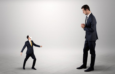 Fototapeta premium Conflict between small and big businessman