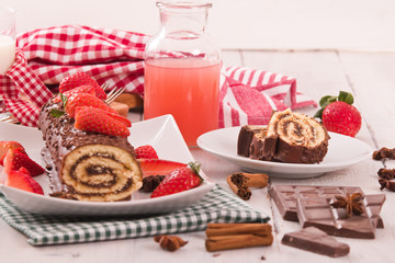 Chocolate roll with strawberries. 