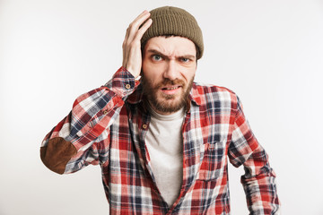 Portrait of a confused bearded man in plaid shirt