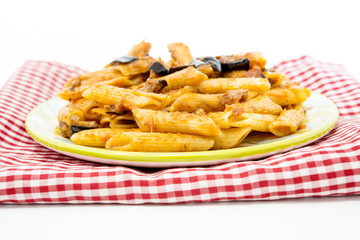 pasta with aubergine and tomato sauce on a the table