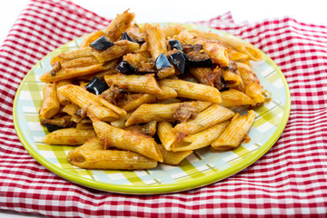 pasta with aubergine and tomato sauce on a the table