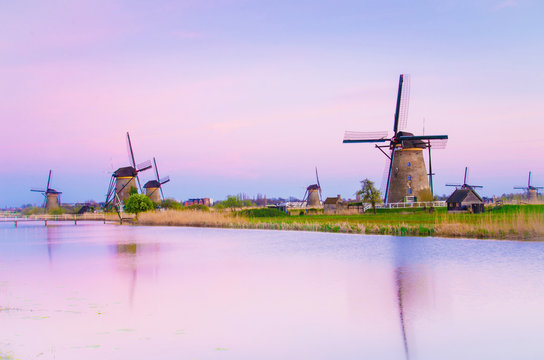 Magic picture of windmills on the river at dawn in Kinderdijk, Netherlands, Europe.