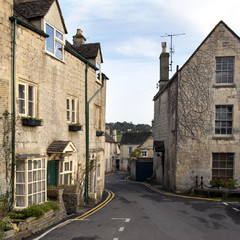 Fototapeta na wymiar Winter sunshine on the picturesque old Cotswold village streets of Painswick, Gloucestershire, UK