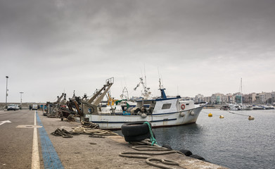 Photograph of a fishing port on a cloudy day. T