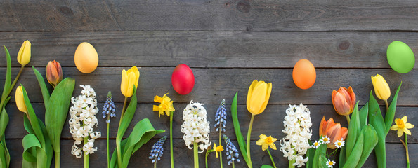 Spring flowers and colorful easter eggs