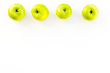 Fresh green apples on white background top view copy space pattern