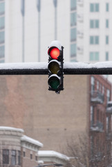 Traffic light outside under a heavy snow