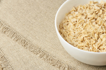 Oatmeal porridge. Healthy food. White bowl. Light background