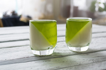 A mixture of milk jelly and kiwi in glasses.