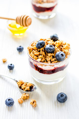 Fitness breakfast with muesli, honey and milk on white table