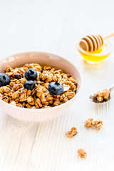 Healthy morning with granola breakfast on white kitchen table