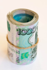 thousand-ruble bills wrapped in a roll and tied with twine