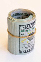 hundred-dollar bills wrapped in a roll and tied with twine