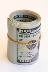 hundred-dollar bills wrapped in a roll and tied with twine