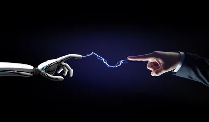 Fotobehang robot and human hand connected by lightning © Syda Productions