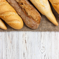 Homemade baguettes on wooden table. close up