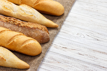 different types of baguette on a wooden background