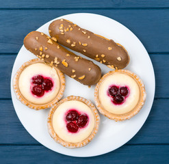 A set of different cakes on a white plate.