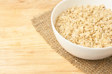 White bowl. Oatmeal porridge. Light background. Healthy food