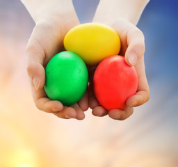 close up of girl holding colored easter eggs