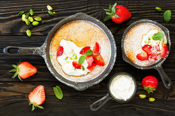 almond pie with cream and strawberries. View from above.